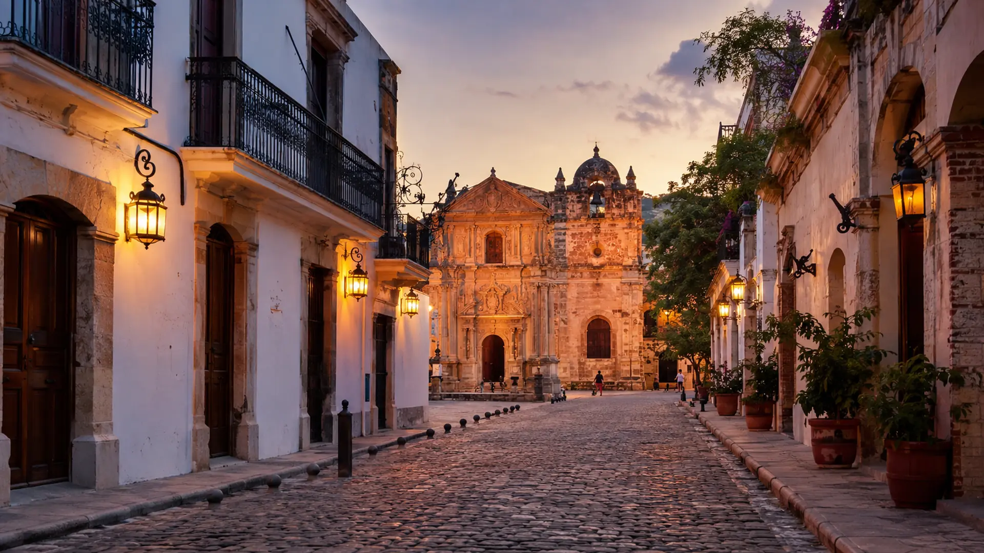 A lantern-lit cobbled street in the Colonial Zone of Santo Domingo leading to a stone church facade at dusk