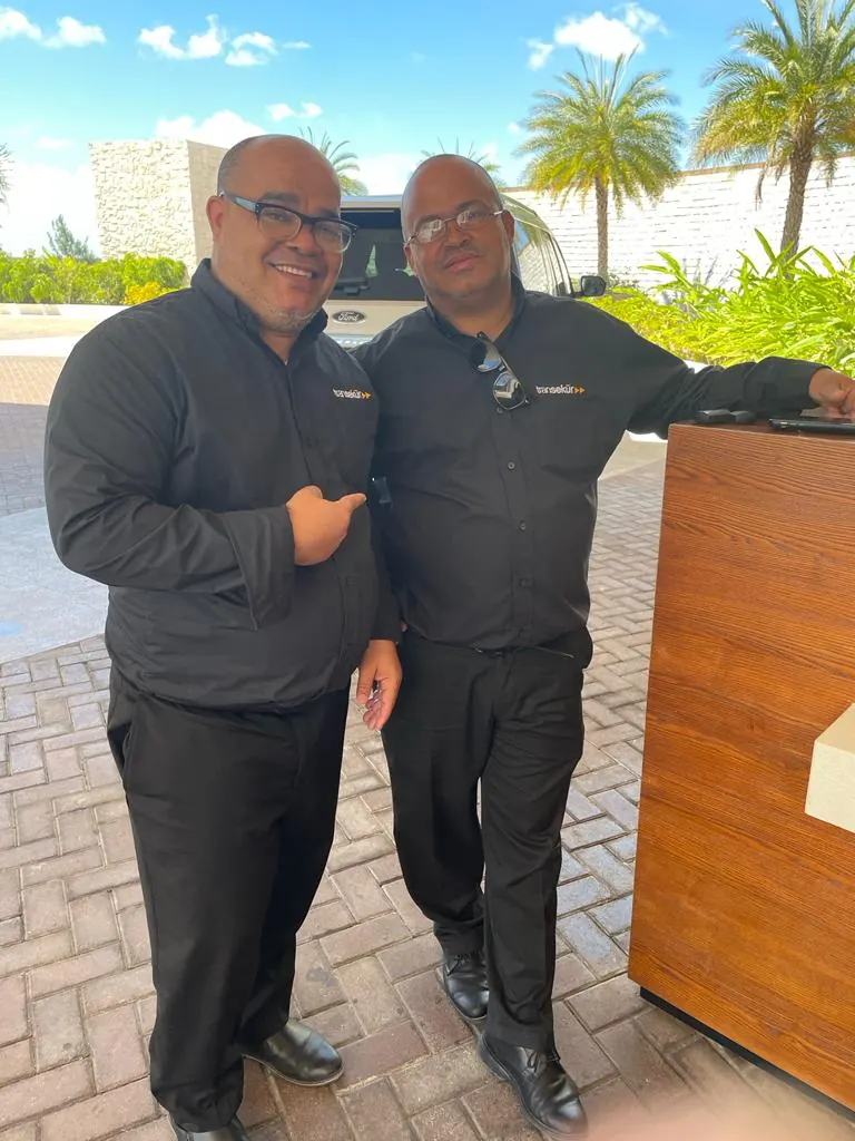 Two uniformed Transekur Transpo staff on location in Santo Domingo