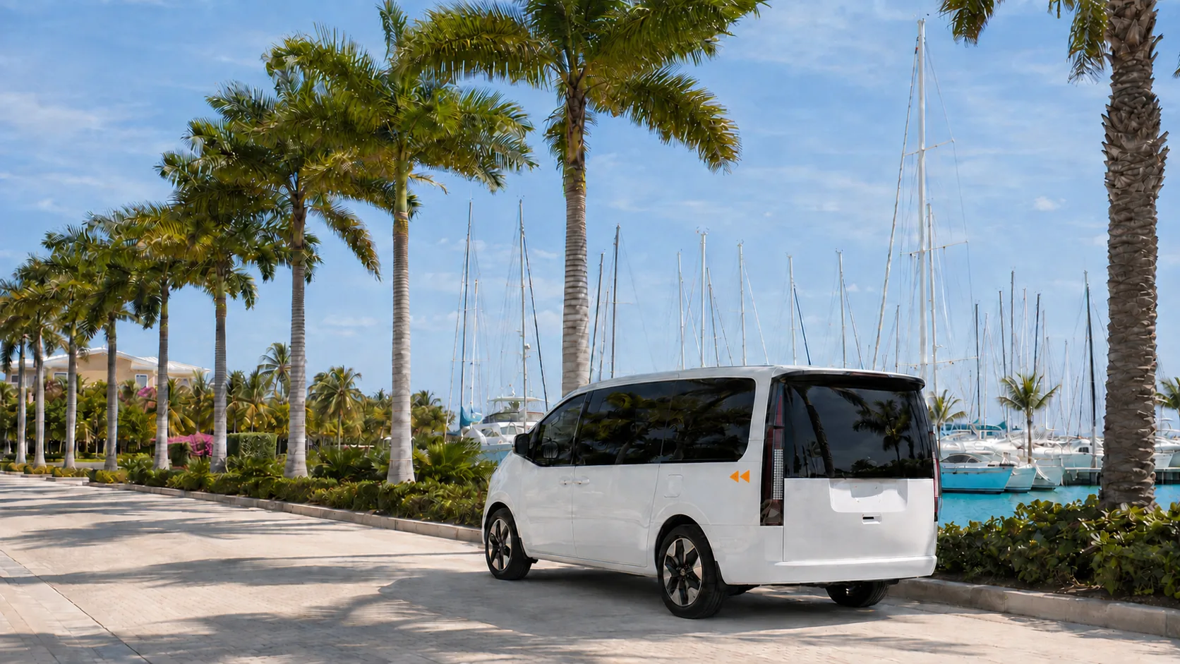 White Hyundai Staria van on a palm-lined marina drive in La Romana